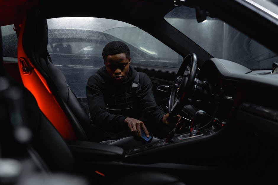 A professional detailer cleaning the interior of a car, ensuring every corner is spotless, creating a luxurious and fresh feel.